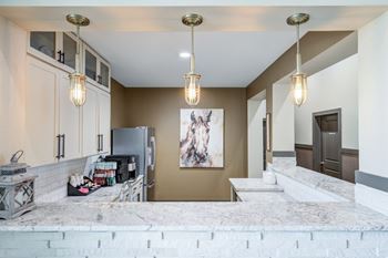 Kitchen with marble countertops and pendant lights
